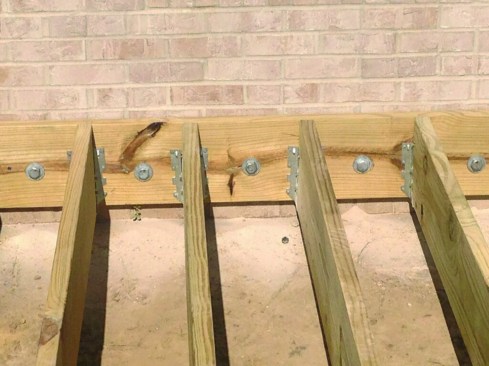 The ledger was fastened to the house rim joist with 3/4-inch-by-8-inch galvanized lag screws installed on 12-inch centers.