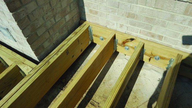 The ledger couldn’t be attached to the masonry chimney, which requires a 1-inch-minimum gap between the brick and the framing.