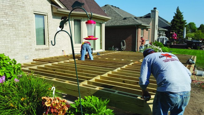 Blocking installed around the perimeter of the frame (left) supports the picture-frame detail used to finish the decking