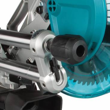 Controls up front. Dual sationary guide rails sit to the left of the blade and run towards the front of the saw. The bevel adjustment knob unlocks and locks the head so you don't have to reach around the saw when adjusting the saw's bevel angle. The blade-change hex wrench tucks into the front of the rails. 