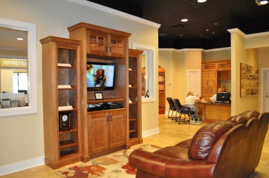 While their wives shop, husbands sometimes like to sit in this comfortable waiting area, equipped with a couch and Direct TV.