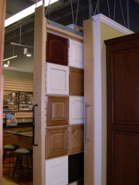 Rolling wall panels allow cabinet doors to be easily displayed, organized, and stored.
