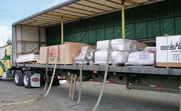 Now that Capitol Lumber's goods have been removed, Henderson will have to re-secure all the remaining goods with straps before closing the curtain and moving on.