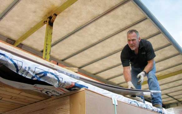 Henderson arranges some trim in such a way that a crew member at Mountain Lumber in Yelm, Wash., can retrieve it.