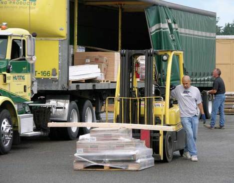 It took nine minutes of waiting in the left-turn lane before Henderson was able to get into the parking lot of Tanglewilde Lumber in Olympia, Wash. He needed just 12 minutes to unload the goods, close up, and head out again.