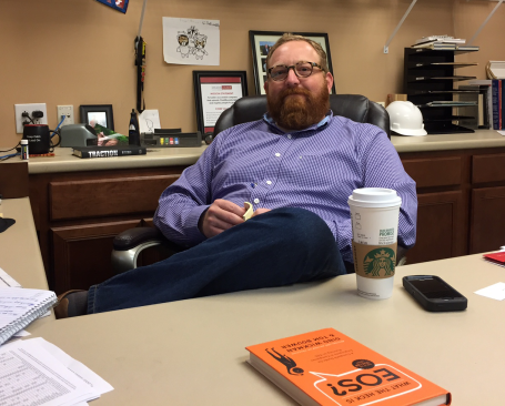 Russ Wilson, sales manager at Wilson Lumber, the 2018 ProSales Dealer of the Year. Note the business advice books on his desk and back counter.