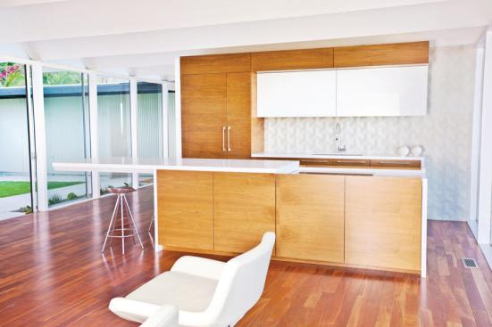 Bradco Kitchens and Baths' sliding kitchen island countertop is remote-controlled and motorized to reveal a cooktop and downdraft while extending counter space. 323.936.3457. www.bradcokitchen.com.
