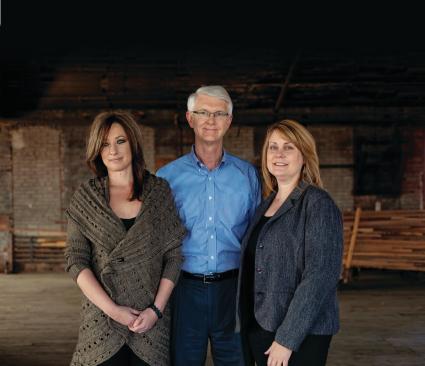 Jill Ruby and Debbie Kracus pose for a portrait with president Alan Pippenger at The Requarth Co. in Dayton, Ohio on October 17, 2012.


